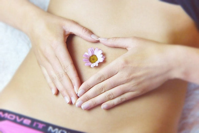  woman’s stomach with a flower on it