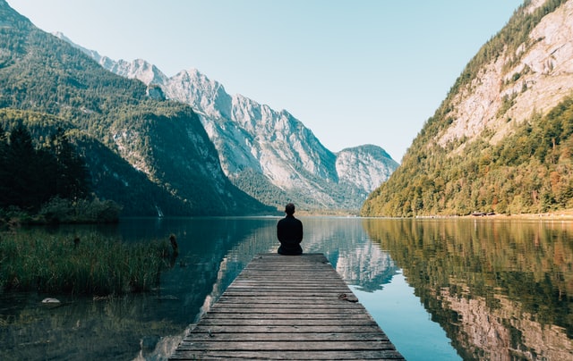 Man sitting at the end of a pier