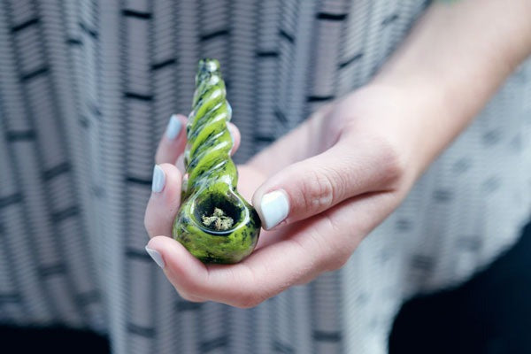 person holding hand pipe