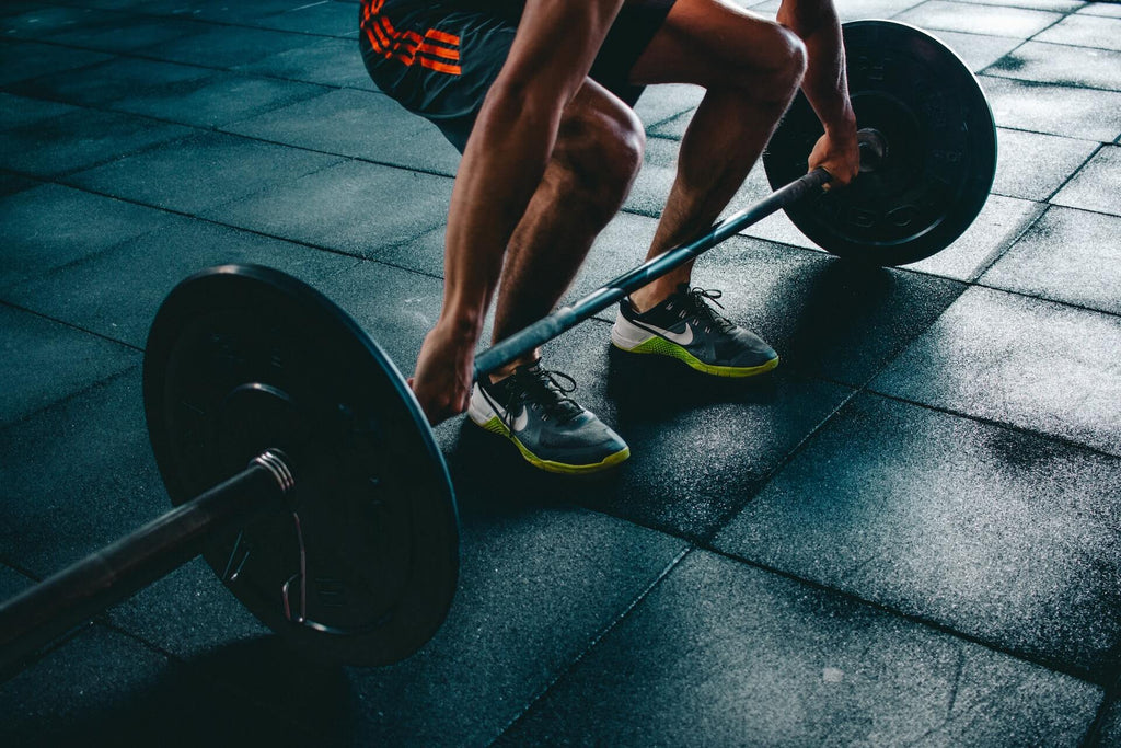 Person squatting to lift weights