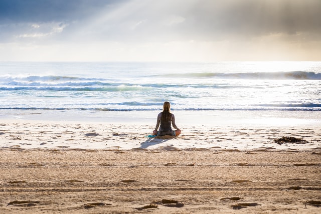 woman meditating for holistic health and wellness